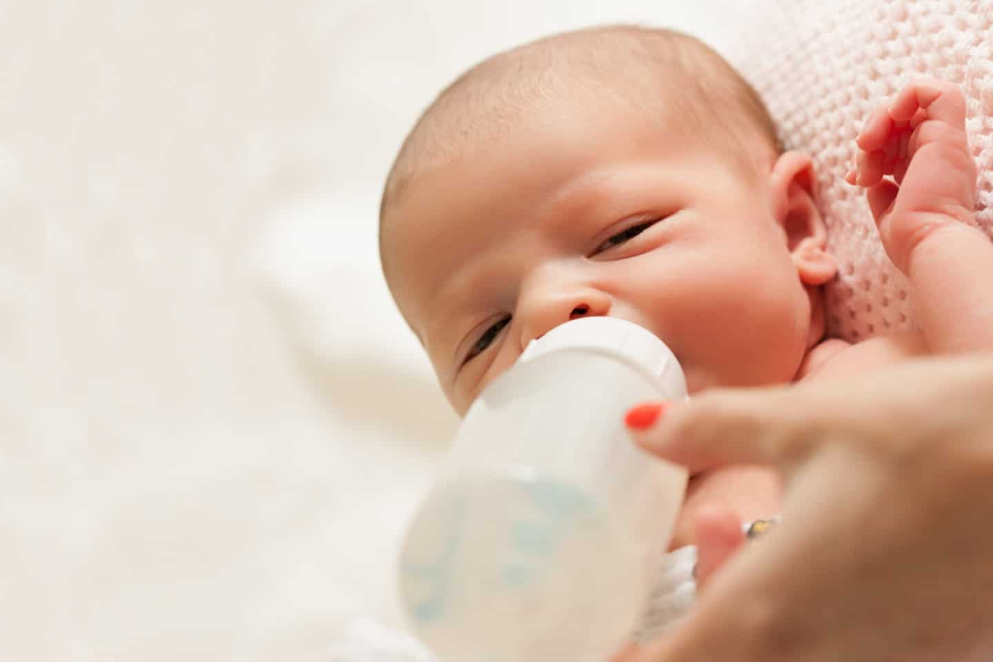 infant taking a bottle