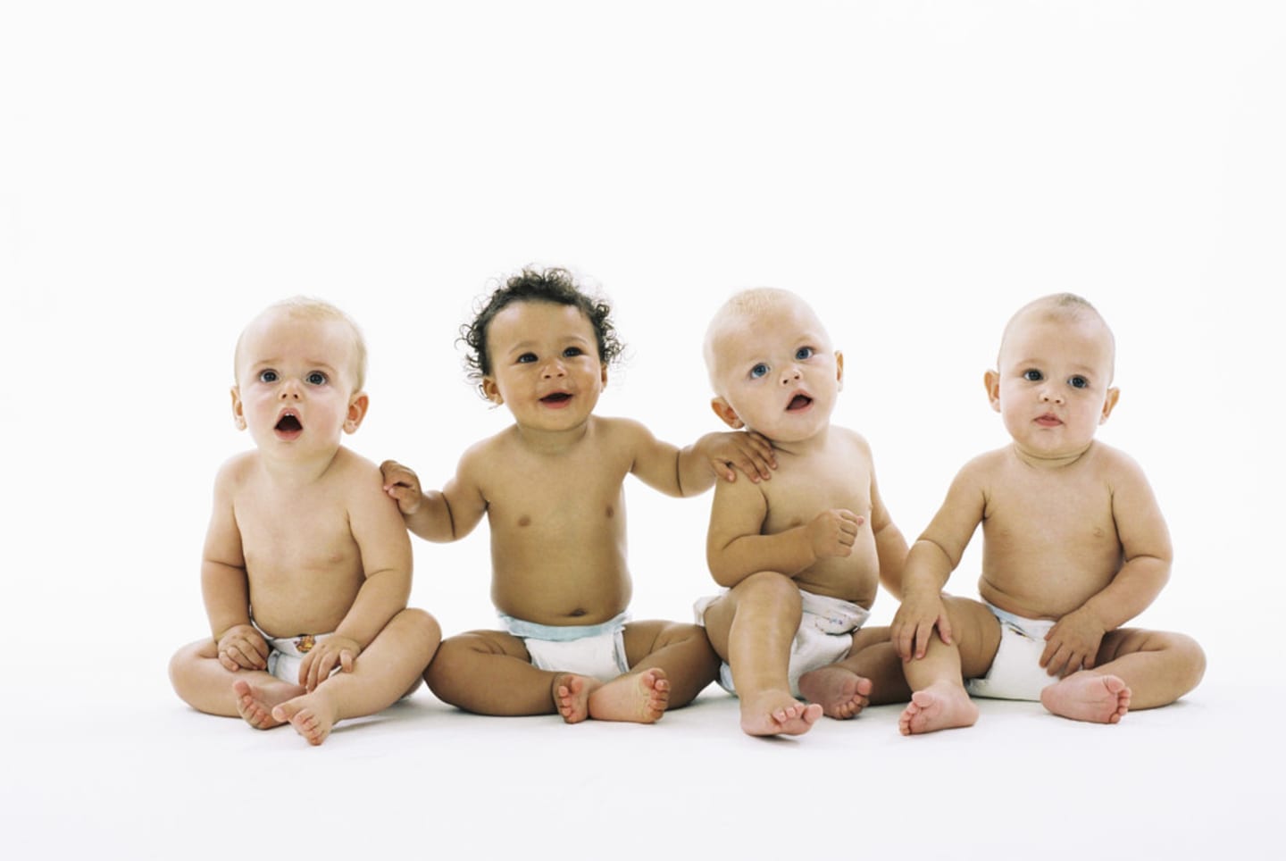 four babies in diapers in photography studio