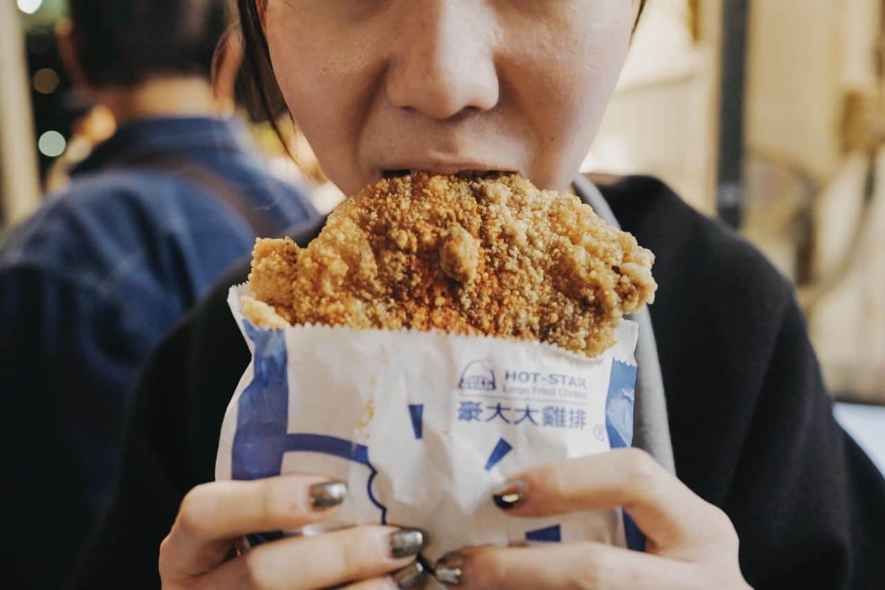 woman eating fried chicken