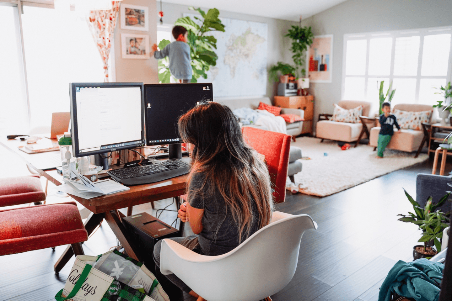 mom working from home while kids play