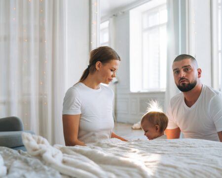 portrait of young happy family on bed in bright living room man and woman in love with cute little t20 gzZW97