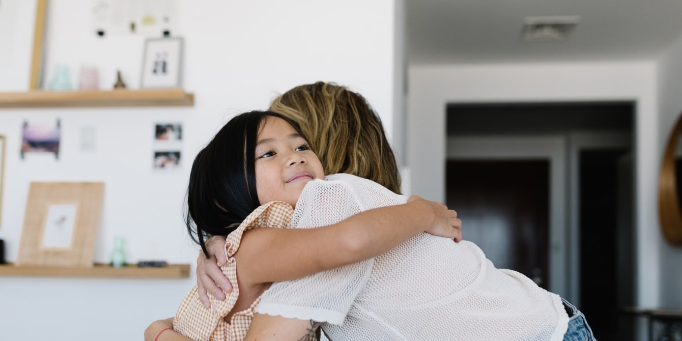 daughter and mother hugging