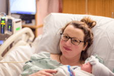 glowing and beautiful new mom holding her daughter for the first time after delivery parenthood young t20 kovP6X Motherly