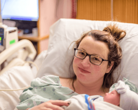 glowing and beautiful new mom holding her daughter for the first time after delivery parenthood young t20 kovP6X Motherly