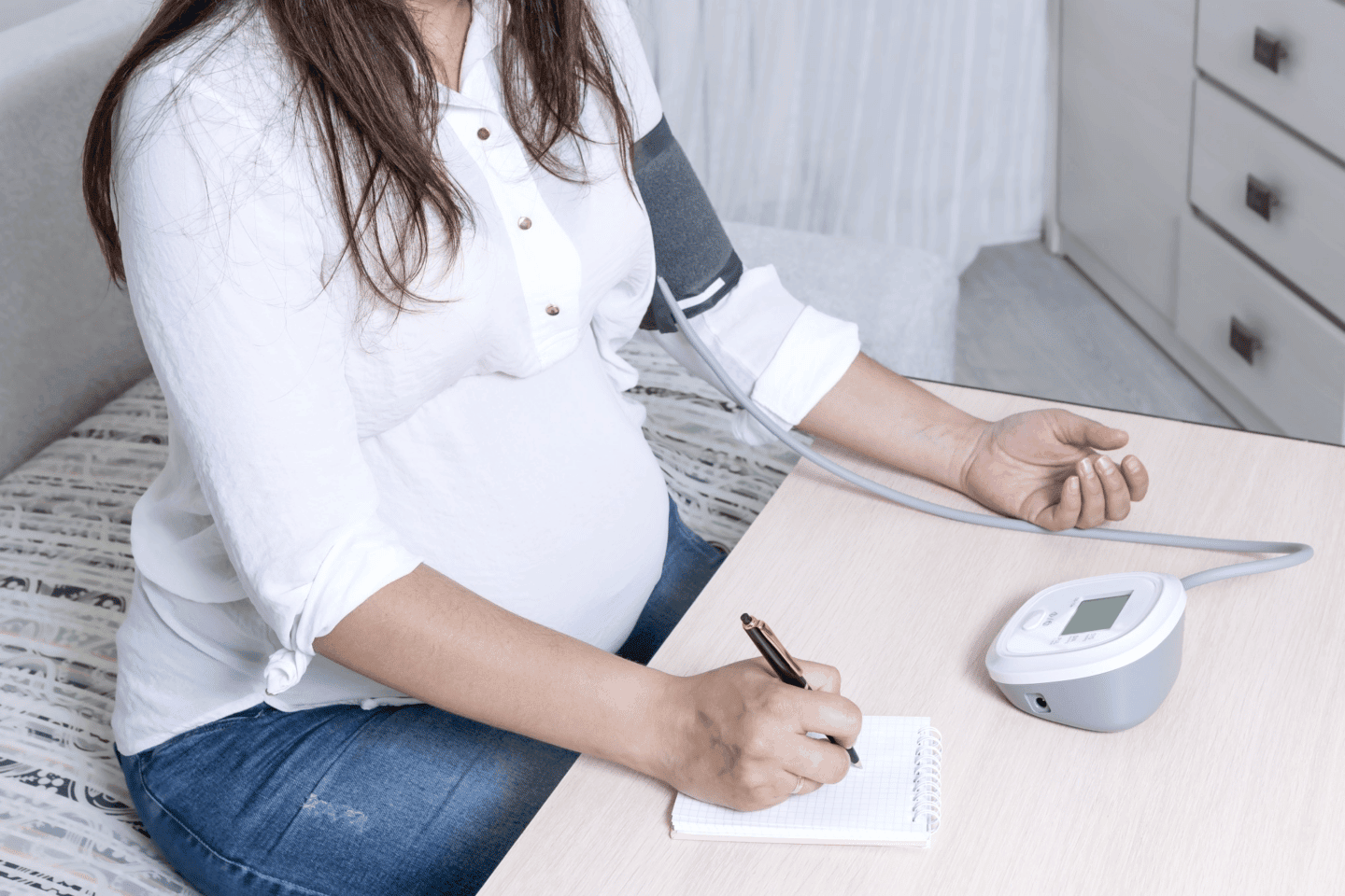 pregnant woman taking blood pressure - how to lower blood pressure in pregnancy