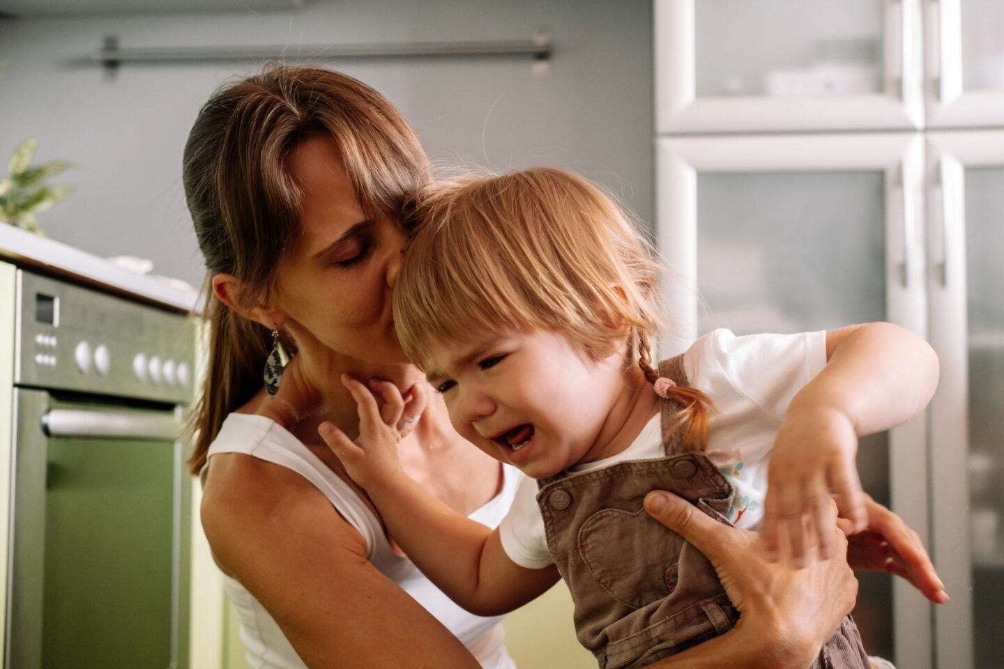 mom trying to console an upset toddler