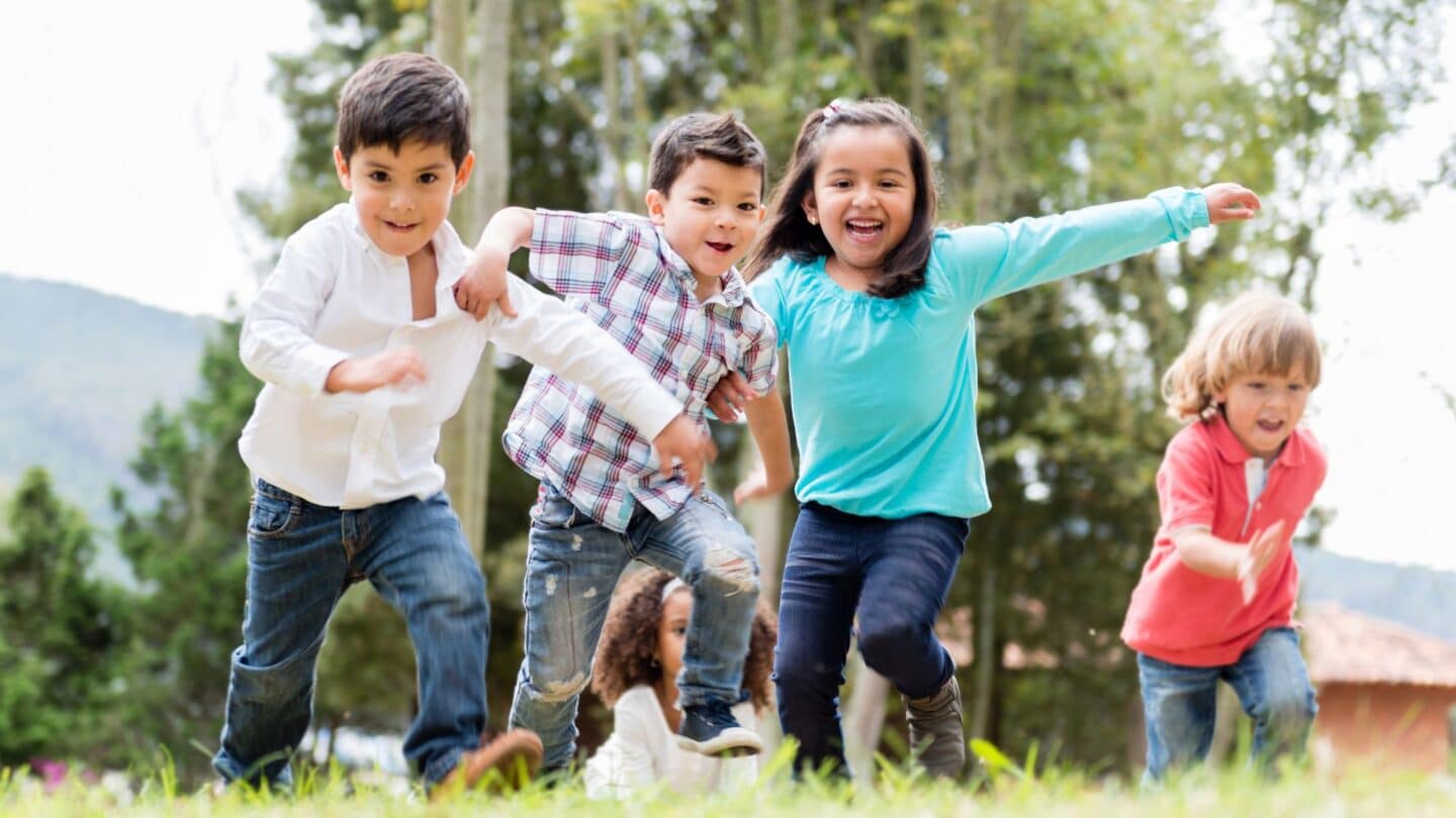 cousins playing in a field