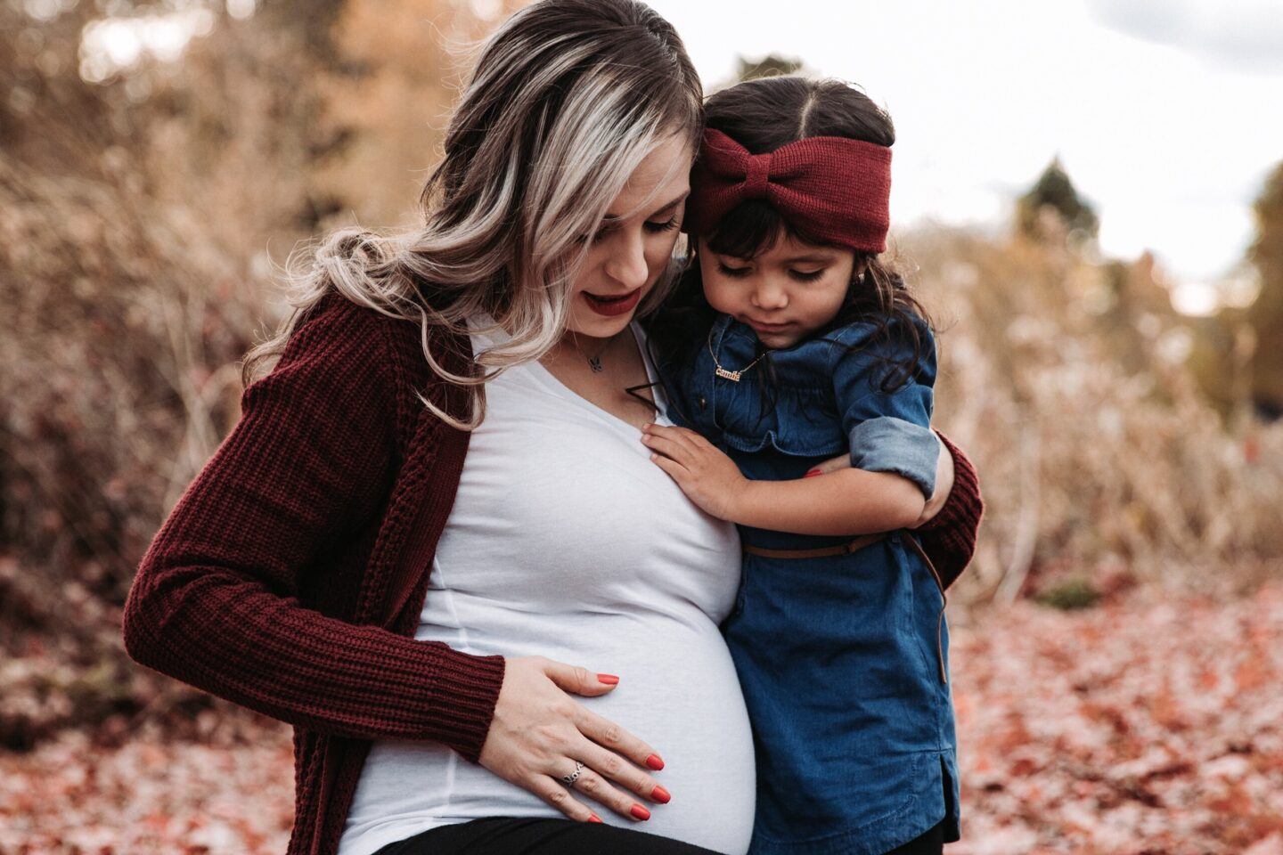 pregnant woman displaying fall fashion maternity wear