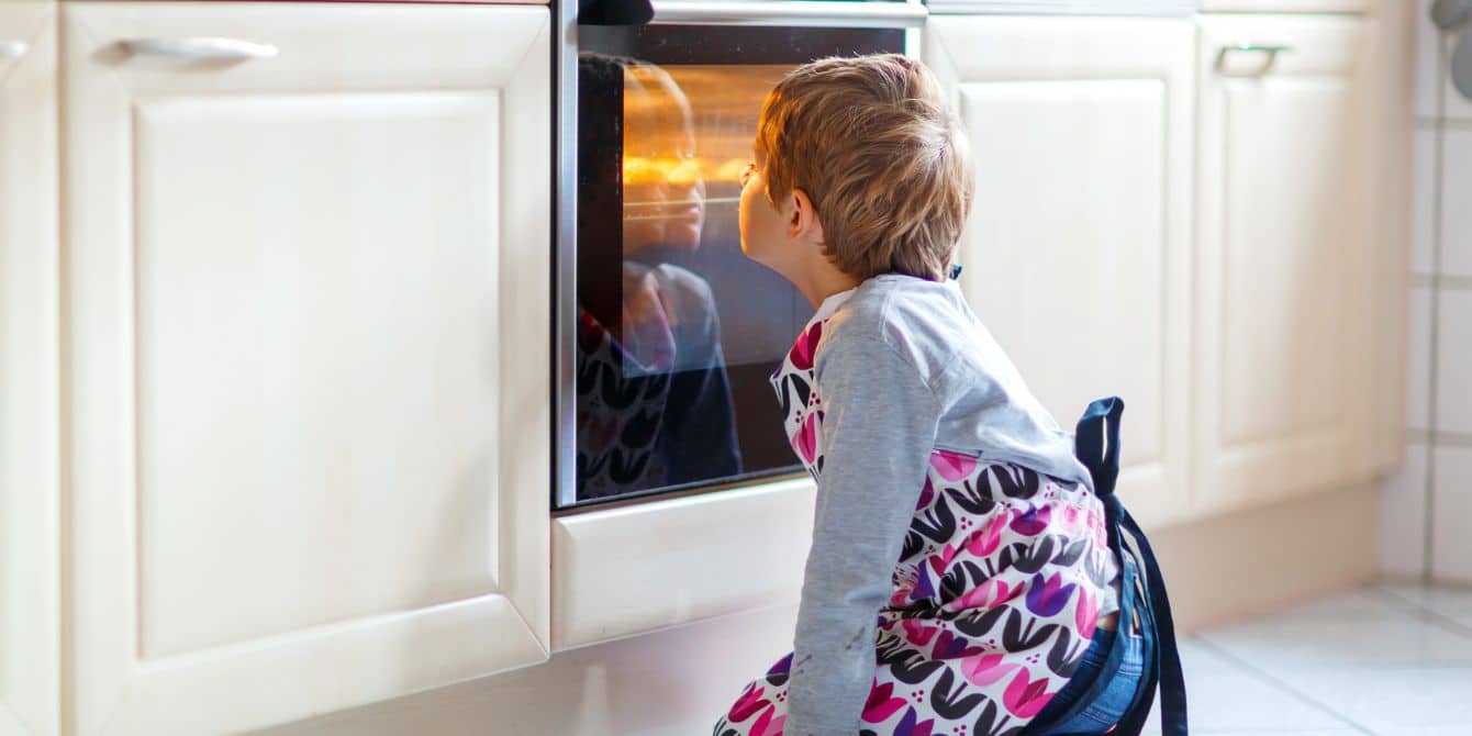 Child helping with thanksgiving prep at oven