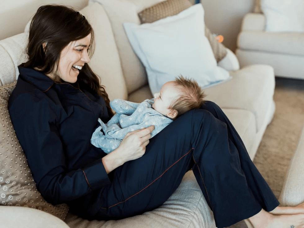 mom holding baby on her knees