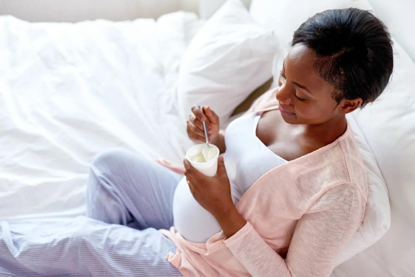 probiotics in pregnancy: pregnant woman eating yogurt