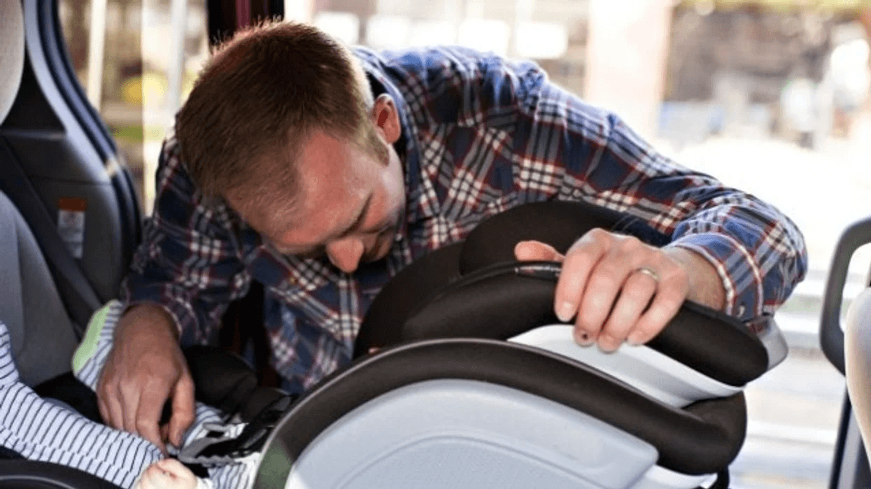 dad putting a car seat in the car