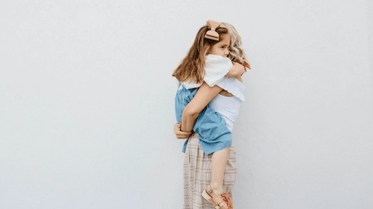 mom hugging little girl