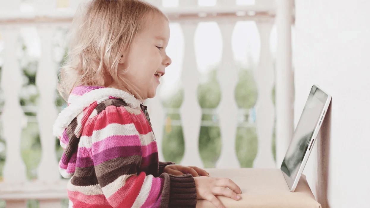 little girl watching a tablet