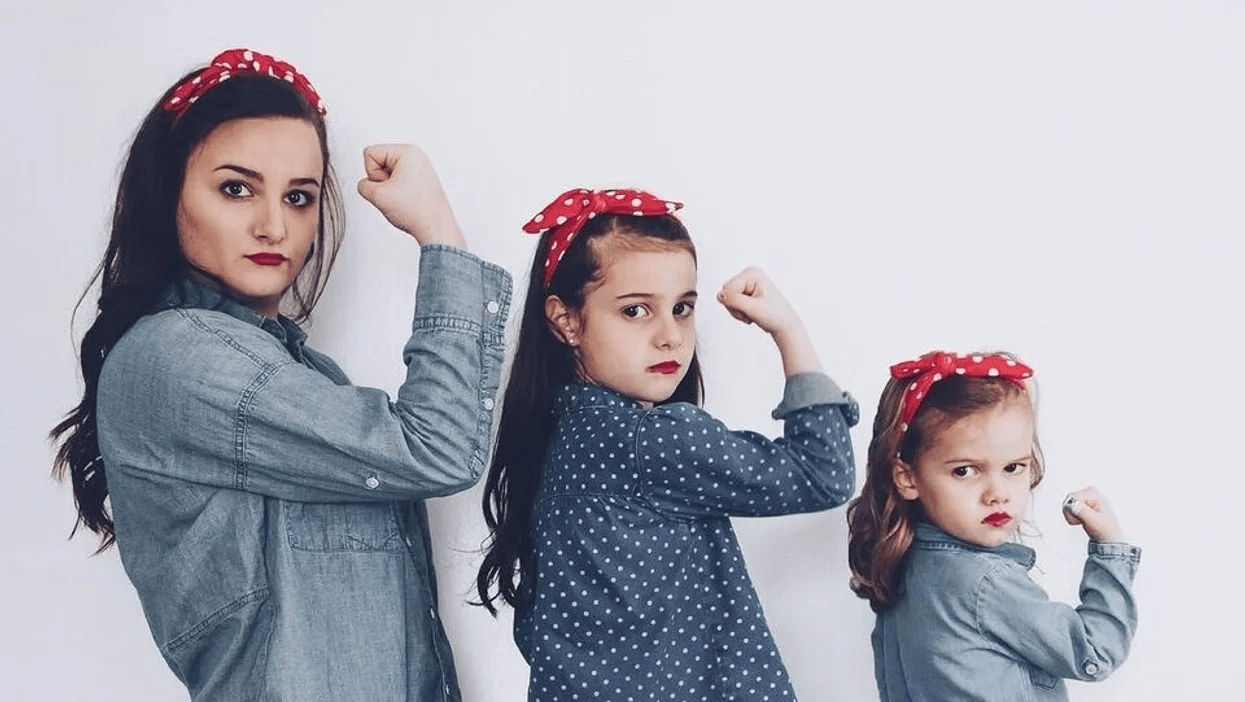 mom and daughters showing arm strength