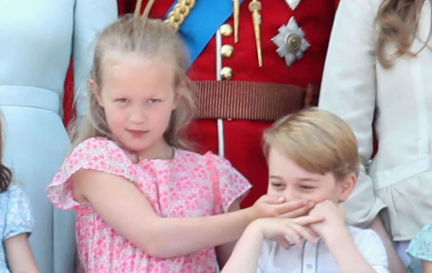 Savannah Phillips covering Prince George's mouth.