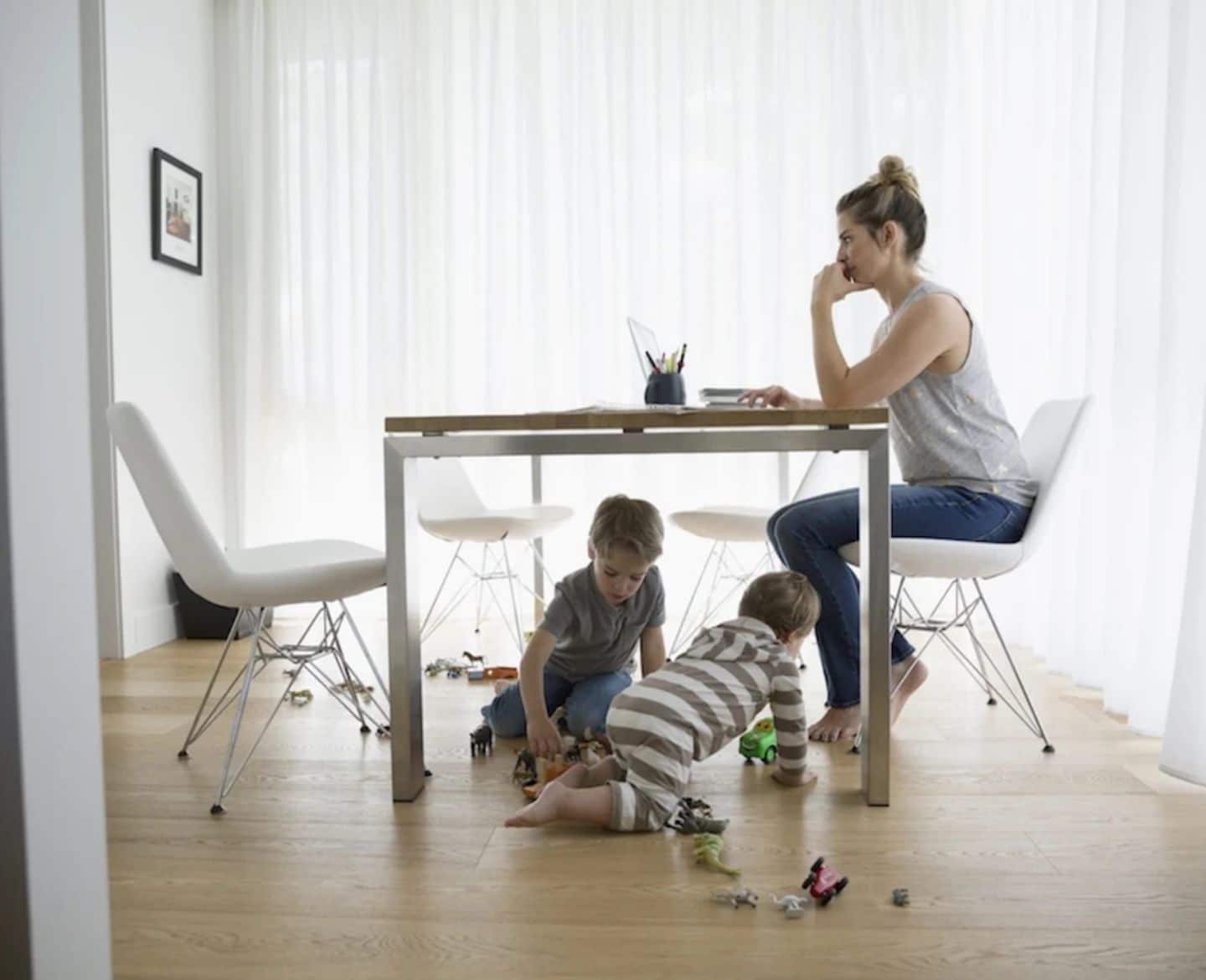 working mom with two kids at her feet