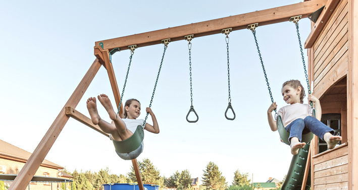 buying a playground set for your backyard 5 questions to ask yourself featured Motherly