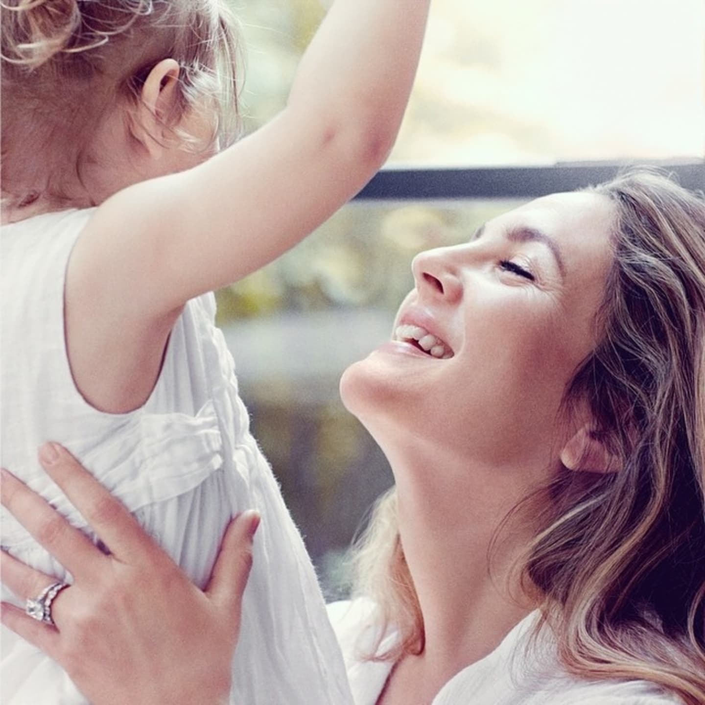 Drew Barrymore holding her child