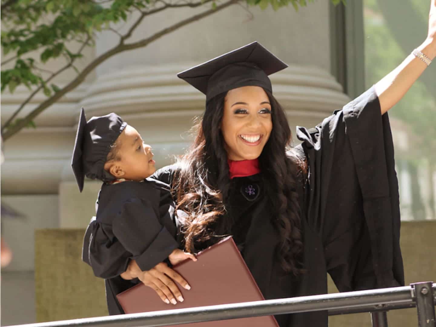 woman and baby wearing graduation toga