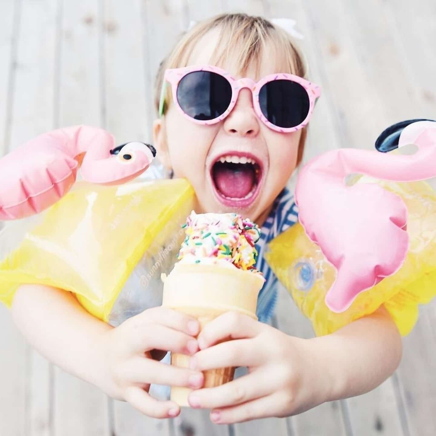 little girl eating ice cream and wearing sunglasses