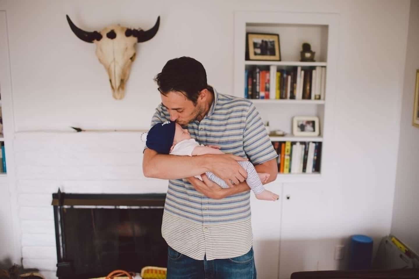 man kissing a baby's forehead