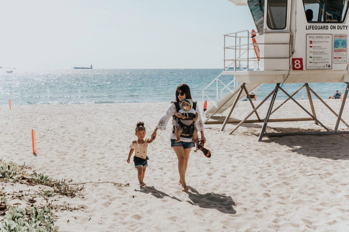 woman and kids at the beach