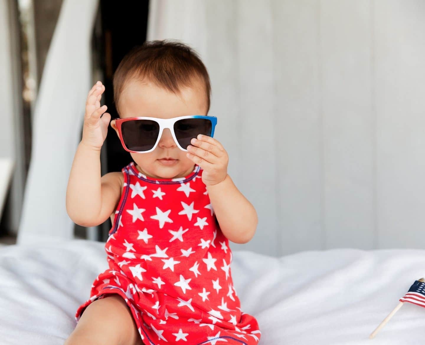 baby wearing fourth of july themed sunglasses- baby's first 4th of july