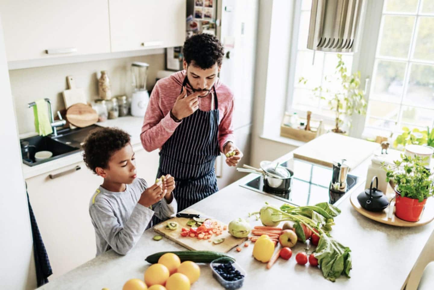 Dad and son cooking in the kitchen