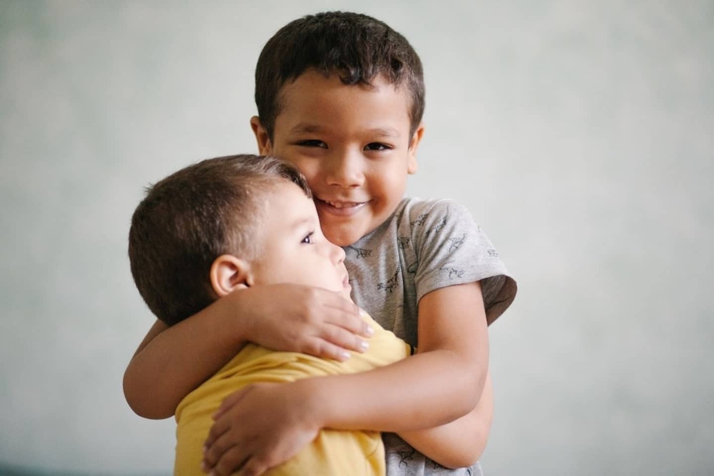 two boys hugging each other