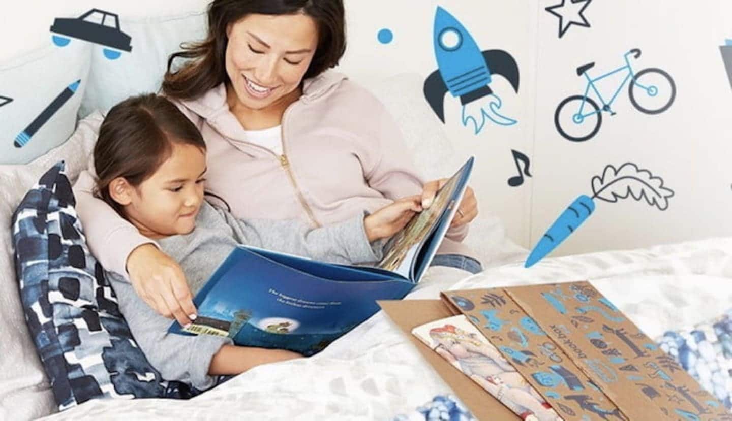 mom reading a book to her daughter