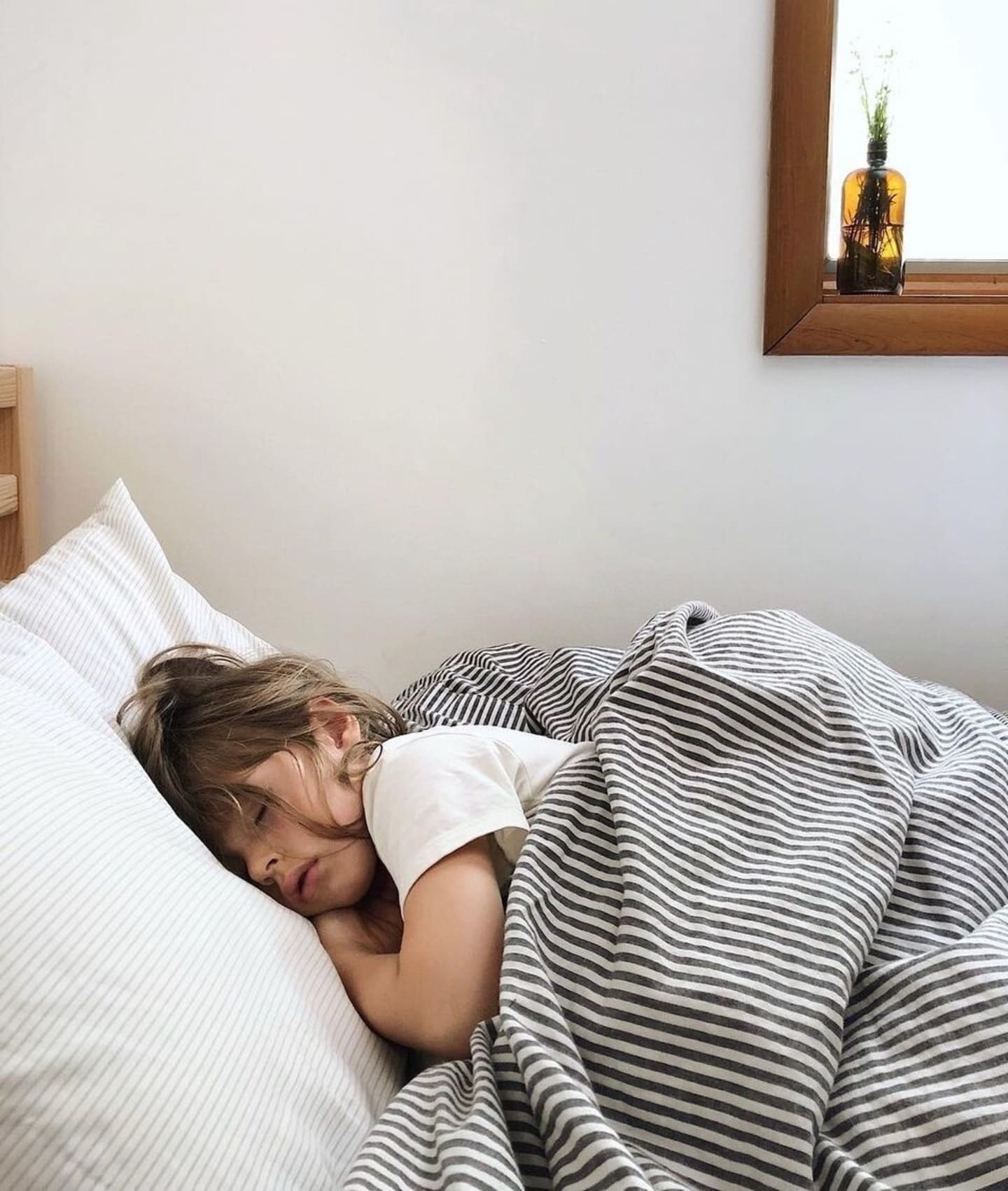 child sleeping on her bed