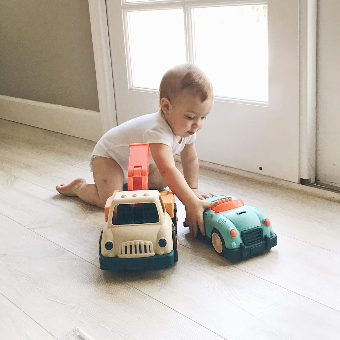 child playing with toy cars/trucks