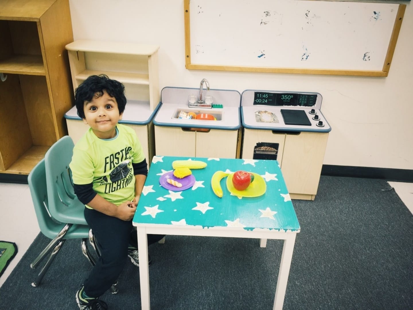 pre schooler sitting in front of a table