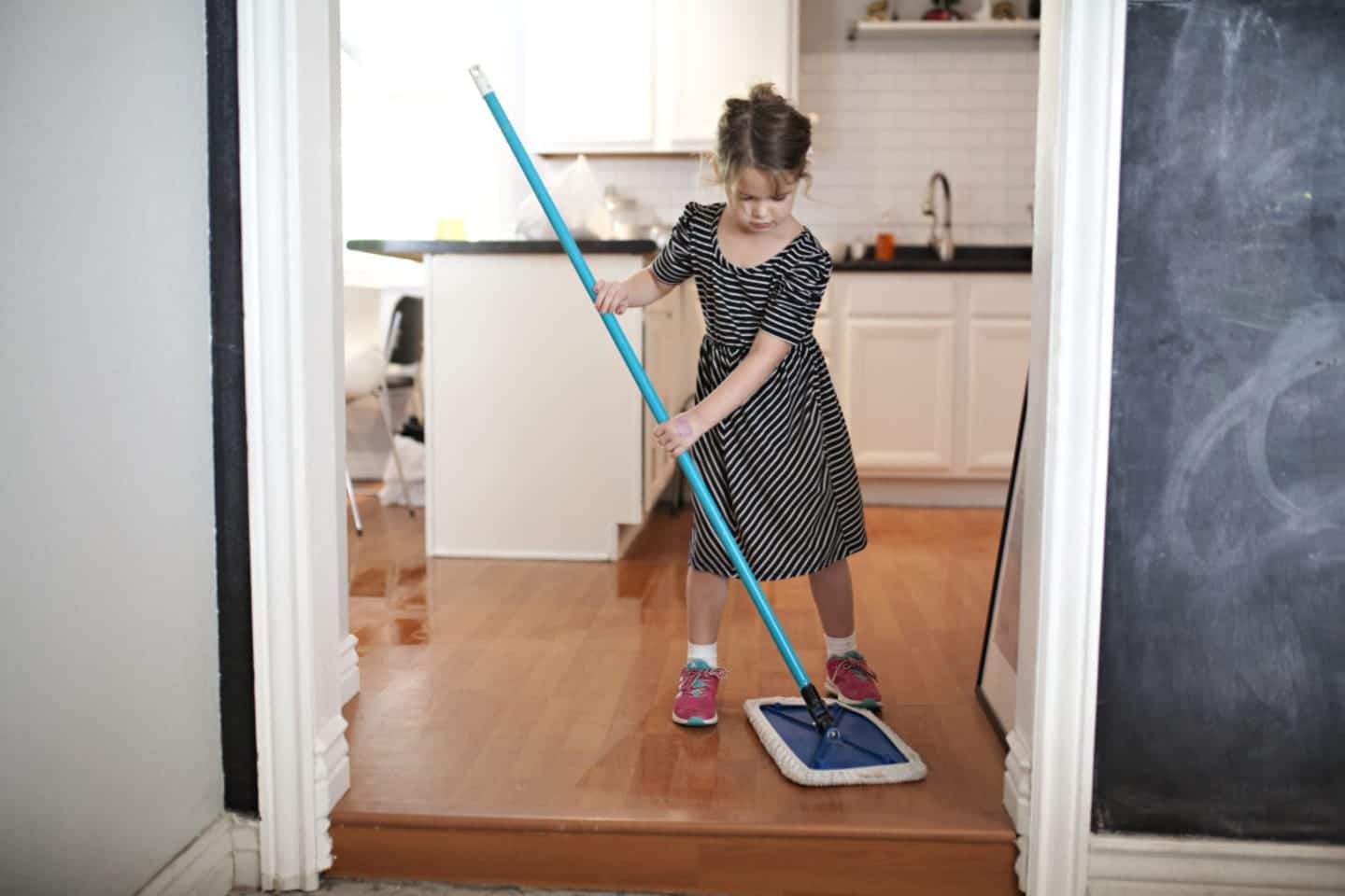 toddler using the mop