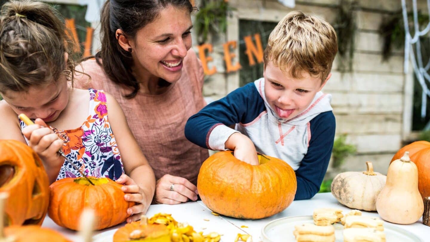 mom and kids pumpkin carving- fall activities for kids