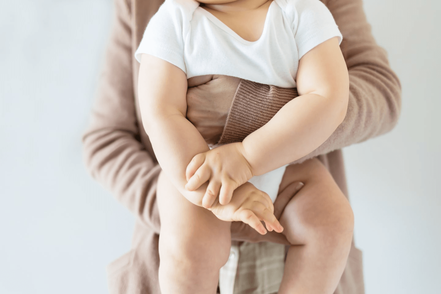 close up of mom holding baby in front of her