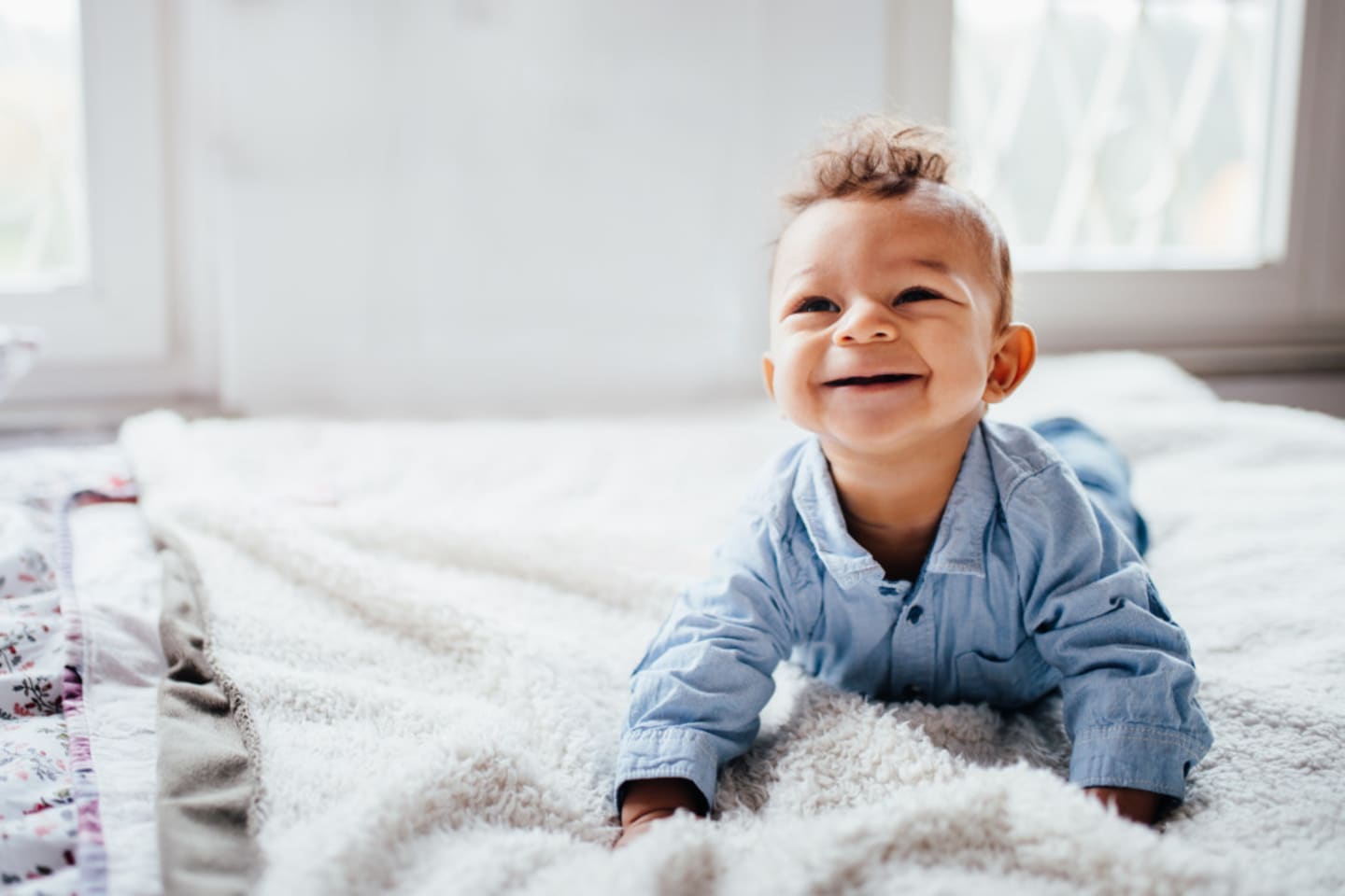 little boy looking up and smiling during tummy time