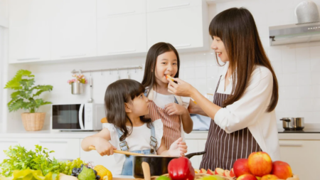 woman cooking with two daughters