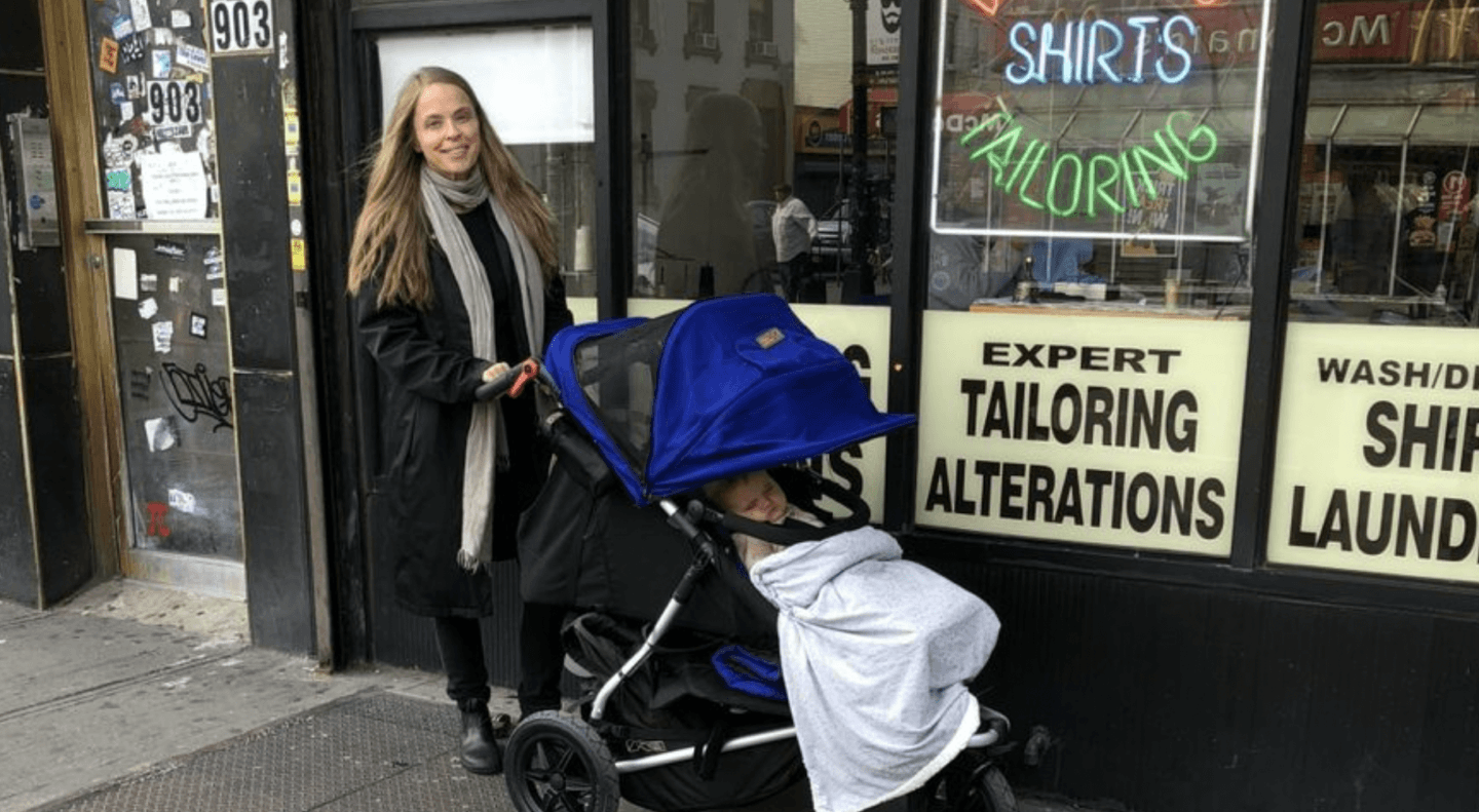 mom pushing baby in a stroller on the street