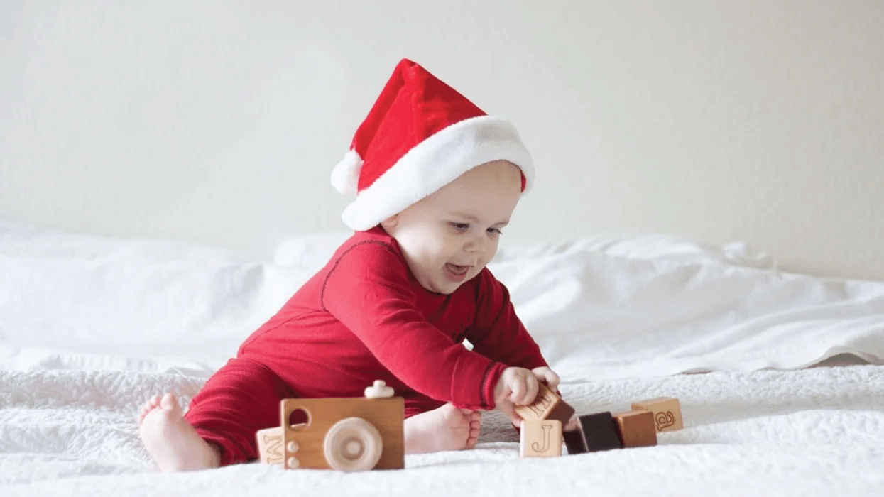 child playing with wooden blocks