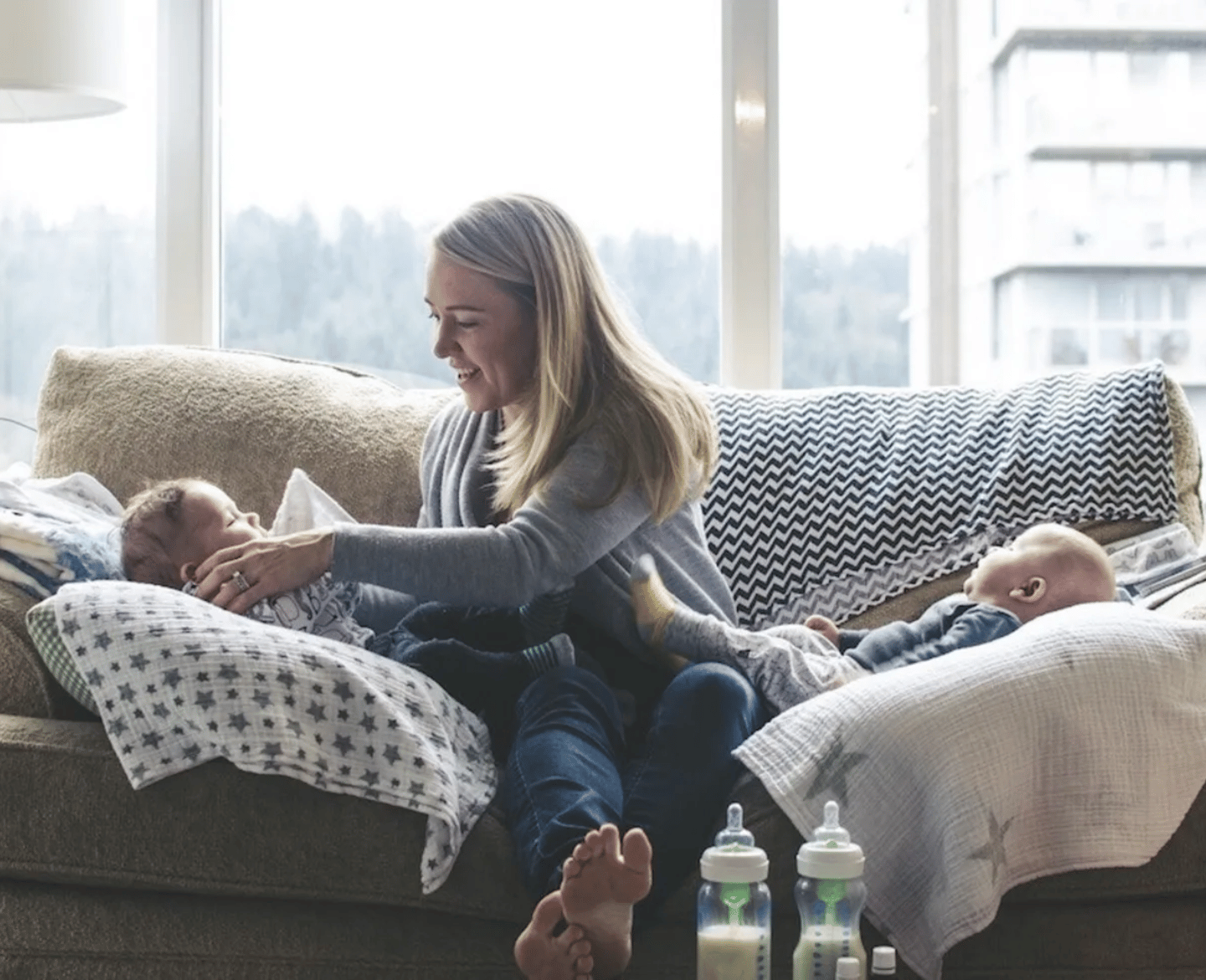 military mom with twins on a couch- life as a military spouse