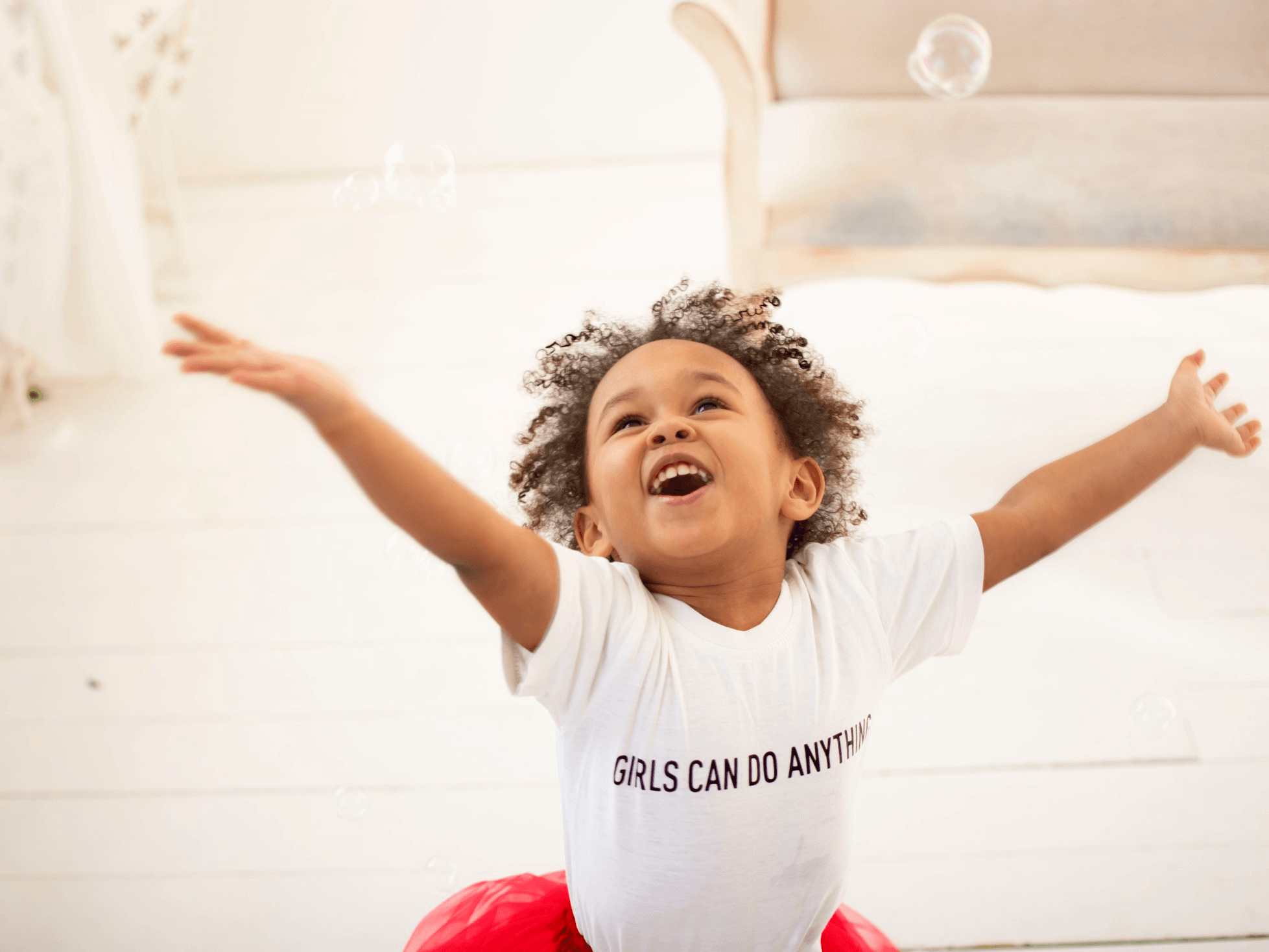 little girl with her hands in the air