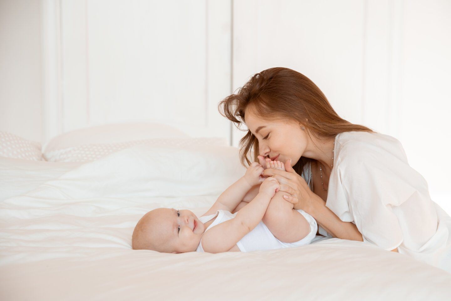 mom kissing baby's foot