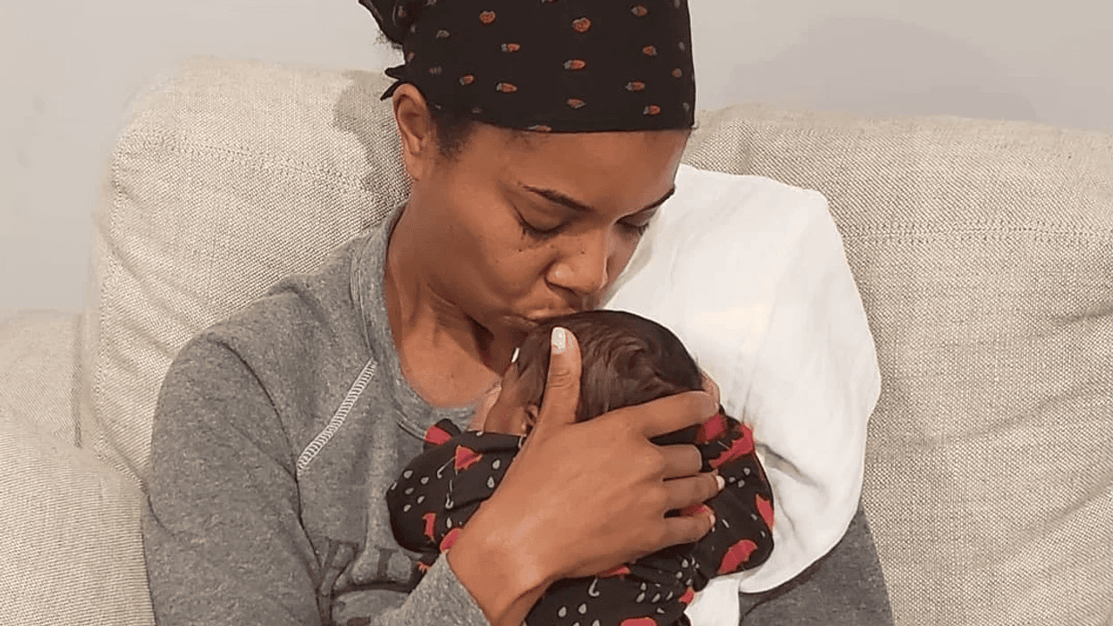 Gabrielle Union-Wade hugging her newborn baby