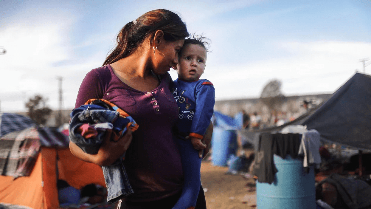 mom holding child at camp