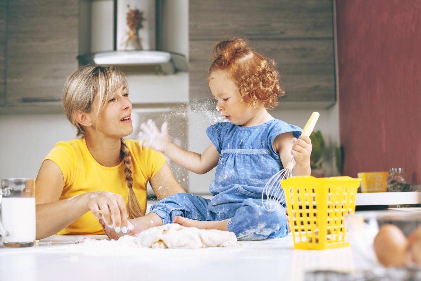 mom and daughter playing in the kitchen