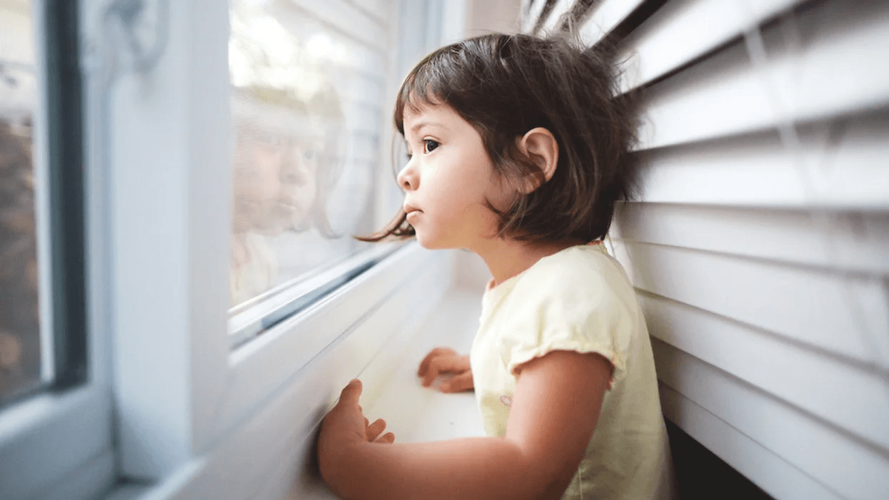 little girl looking out window