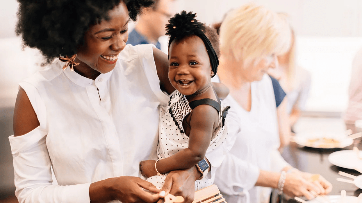 mom holding smiling baby