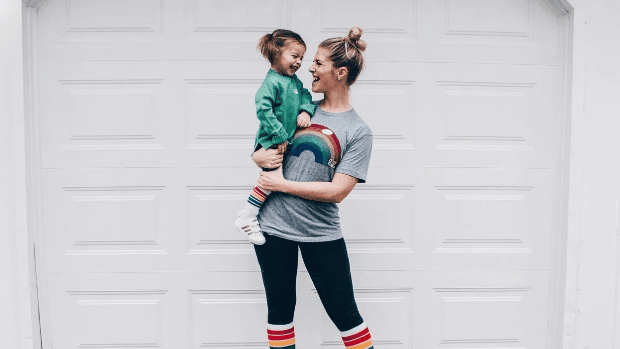 mom holding a toddler girl